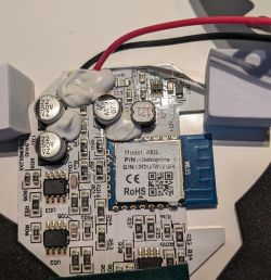 Close-up of an electronic circuit with a WB3S module and several capacitors.