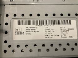 Etykieta z danymi technicznymi radia samochodowego Becker BE6802 na metalowej obudowie.