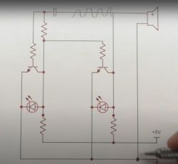 Schemat elektroniczny z tranzystorami, głośnikiem i diodami LED.
