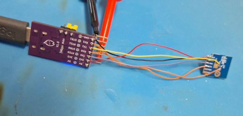 CH342 USB-C module with wires connected to a peripheral device on a blue mat