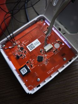 Close-up of red PCB with wires connected and labeled RTX1211 module