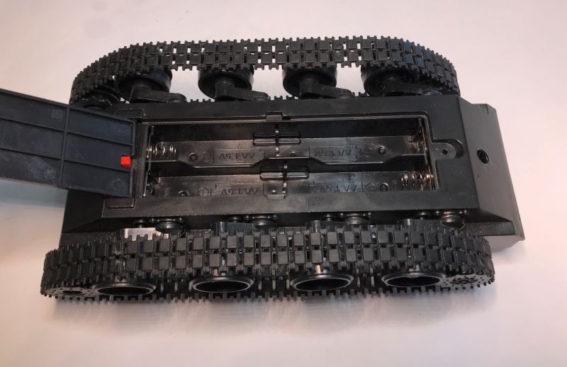 Robot Chassis with Battery Compartment View of a robot chassis with tracks and AA battery compartment.