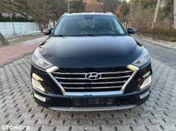 Front view of a black Hyundai SUV parked on a paved road.
