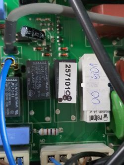 Close-up of a boiler's main board with visible electronic components and labels.