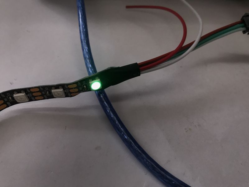 Controlling WS2812B LED Strip WS2812B LED strip with a lit green diode and connecting wires.
