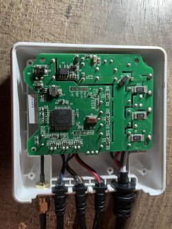 Close-up of the internal circuit board of a 3-phase energy meter with visible electronic components.