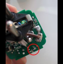 Close-up of damaged D1 diode on green PCB, highlighted with a red circle
