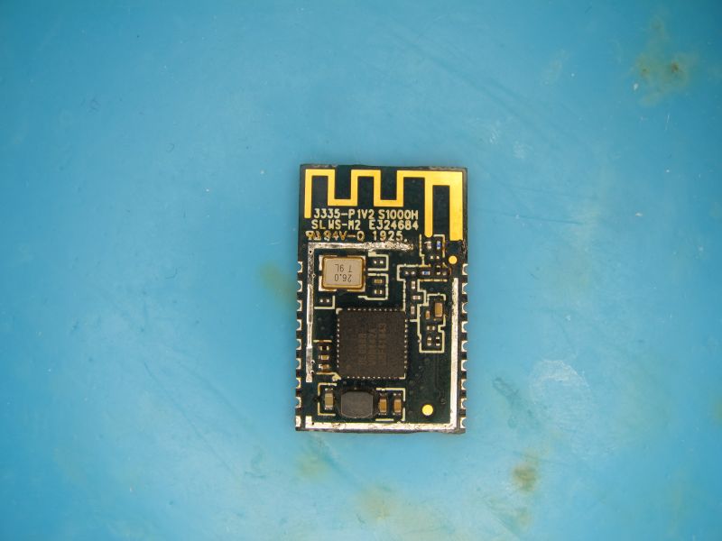 Electronic module with PCB antenna and component markings on a blue surface