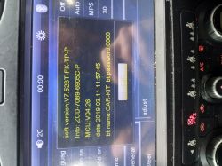 Car radio screen showing firmware version and system information