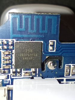 Close-up of a blue PCB section with a 3427CWYSA chip, visible traces, and a PCB antenna.