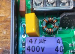Close-up view of LED power supply showing a toroidal choke and a 47 µF 400 V capacitor.