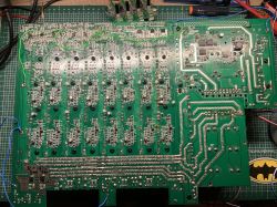Circuit board with multiple electronic components on a green background.