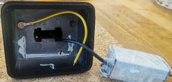 Image of the interior of a lamp housing with wires and mounting elements.