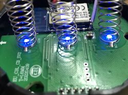 Interior of Triple Switch N-TS10-EU-B3 with LEDs View of the interior of the triple wall switch N-TS10-EU-B3 with blue LED lights and circuit components on the PCB.