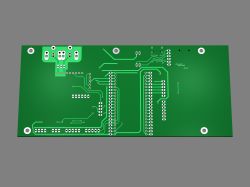 Green printed circuit board with connections on a gray background.