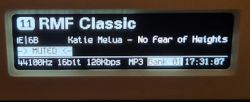 Display screen showing the currently playing song on the radio.
