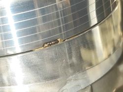 Zbliżenie na głowicę obrotową magnetowidu z widocznym zużyciem lub zanieczyszczeniem na jednej z głowic wizyjnych.