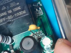 Close-up of a circuit board with a soldered capacitor and components.