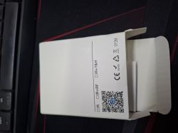 Black, round Tuya wifi-IR-1 module with a small LED on the casing, shown on a white background.