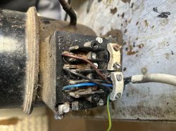 Close-up of motor wiring with visible wires and two unused terminals