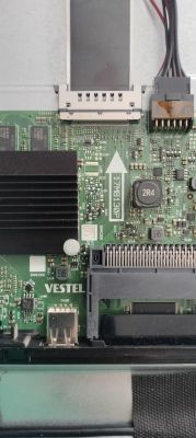 Close-up of a Vestel PCB with a heatsink, ribbon connectors, and wires.