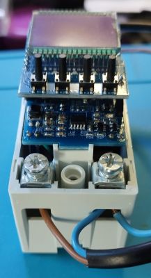Disassembly of Electronic Device Modular electronic device with a PCB and buttons.