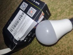 LED bulb and damaged box on a carpet background.