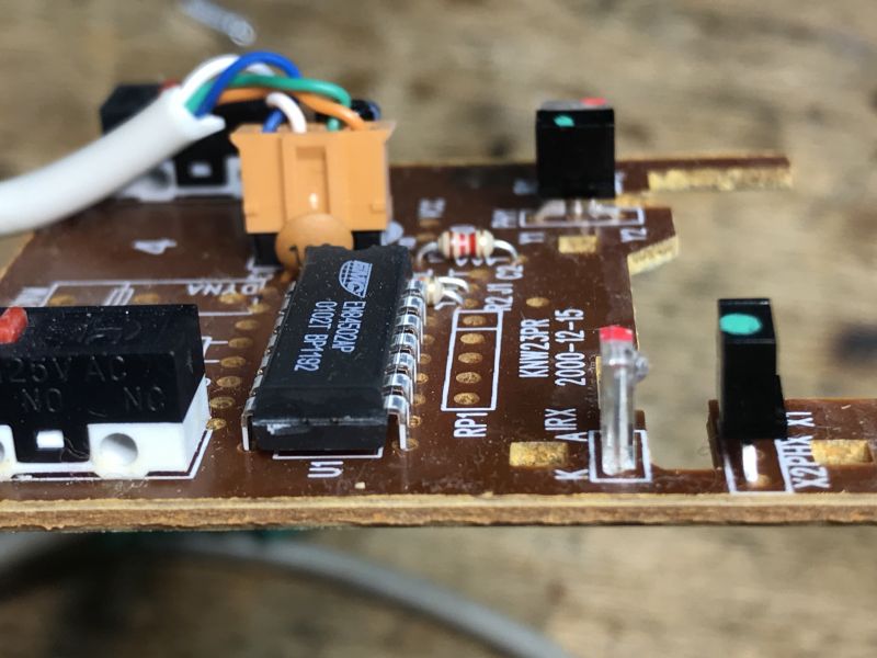 Computer Mouse Printed Circuit Board Printed circuit board with electronic components from an old computer mouse.