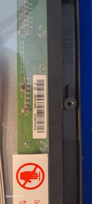 Scan of a circuit board part with a barcode and markings in a TV.