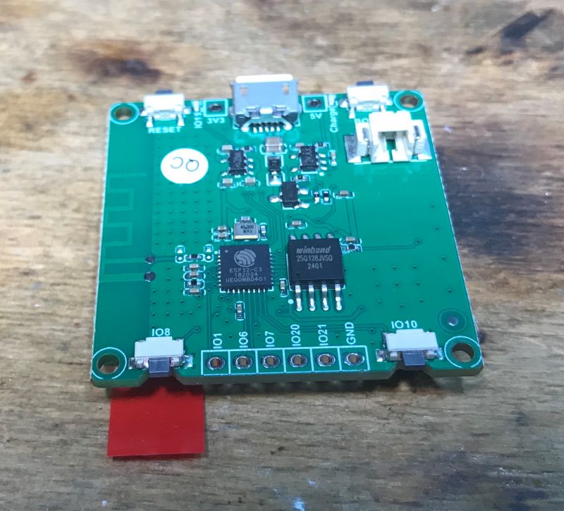 Circuit Board with ESP32-C3 and Winbond Image of a green circuit board with an ESP32-C3 and Winbond chip.