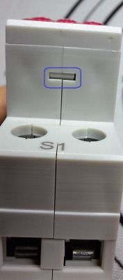 Close-up of an electrical terminal block labeled S1 with two wire insertion points