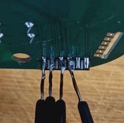 Circuit Board with Extension Wires The image shows a circuit board with soldered extension wires on pins.