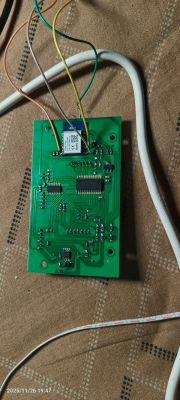 Green PCB with SIM800L module and colored jumper wires attached