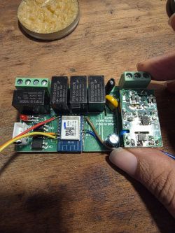 Electronic board with relays and Wi-Fi module on a wooden surface