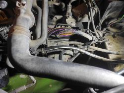 Damaged wire bundle above starter motor in engine bay
