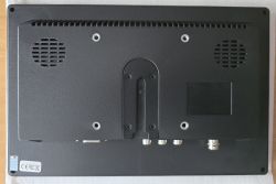 Back of a black LCD monitor with ventilation grilles and several metal connectors along the bottom edge