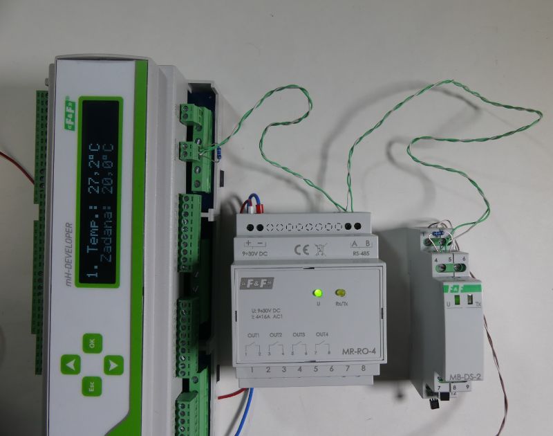 Panel z wyświetlaczem oraz moduły F&amp;F MR-RO-4 i MB-DS-2 z okablowaniem na białym tle