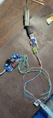 Electronic setup with power supply, cables, and module.