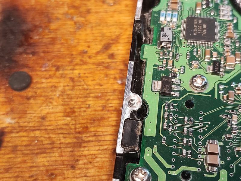 Close-Up of Hard Drive Electronics Close-up of hard drive electronics with visible components on a green PCB.