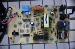 PCB with power-supply parts: relay, coils, capacitors, heatsink, and connected wires