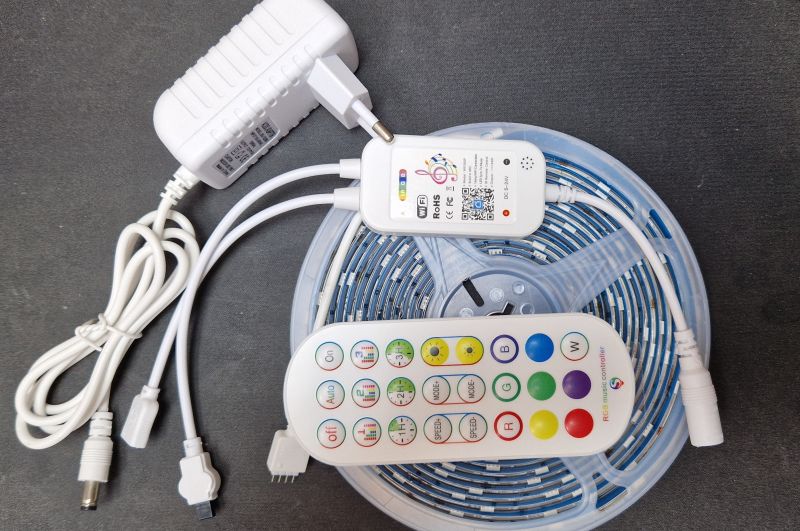 Tuya LED strip control kit with controller, strip, power supply, and remote.