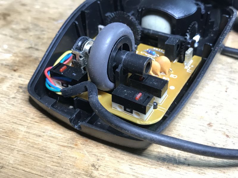 Inside a Ball Mouse with Scroll Wheel Interior of an old ball mouse with circuitry and scroll wheel