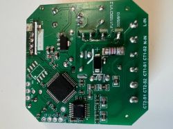 Green PCB with microchips, resistors, connectors, and labeled terminals