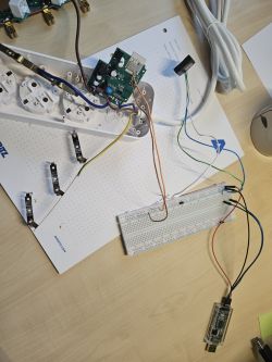 Dismantled Eightree Power Strip with Connected Wires Dismantled smart power strip with a circuit board and wires connected to a breadboard.