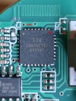 Close-up of T34 chip on PCB with labeled GND, RX, TX, and 3.3V pins in red