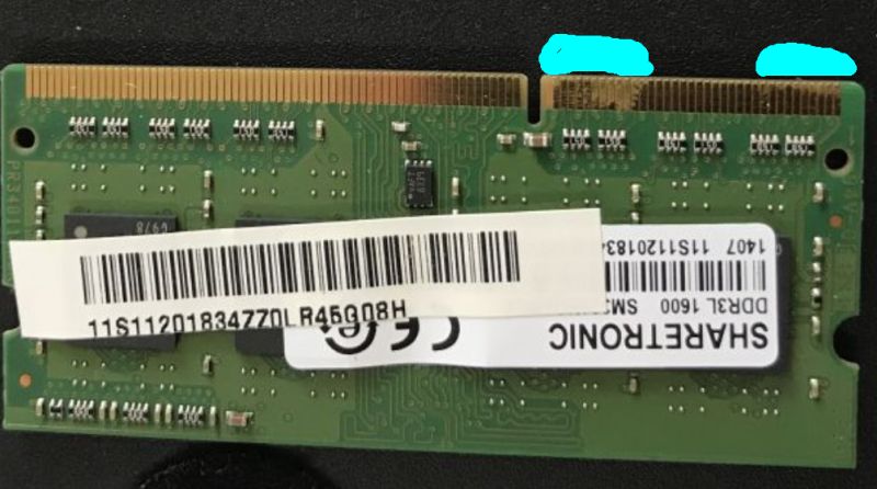 Close-up of a SO-DIMM RAM module edge connector with gold contacts and a center notch.