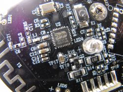 Close-up of a printed circuit board with various electronic components, including a microchip.