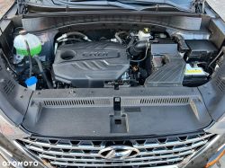 Car engine bay with “CRDi” engine cover, fluid reservoir, and battery