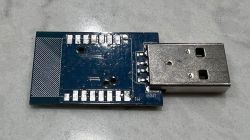 TCWBRCU1 PCB with USB connector after WBR3 removal TCWBRCU1 electronic module PCB with exposed solder pads and USB-A connector on a blue board.