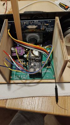 Inside a wooden enclosure with a PCB, ESP32 module, and multiple connected wires